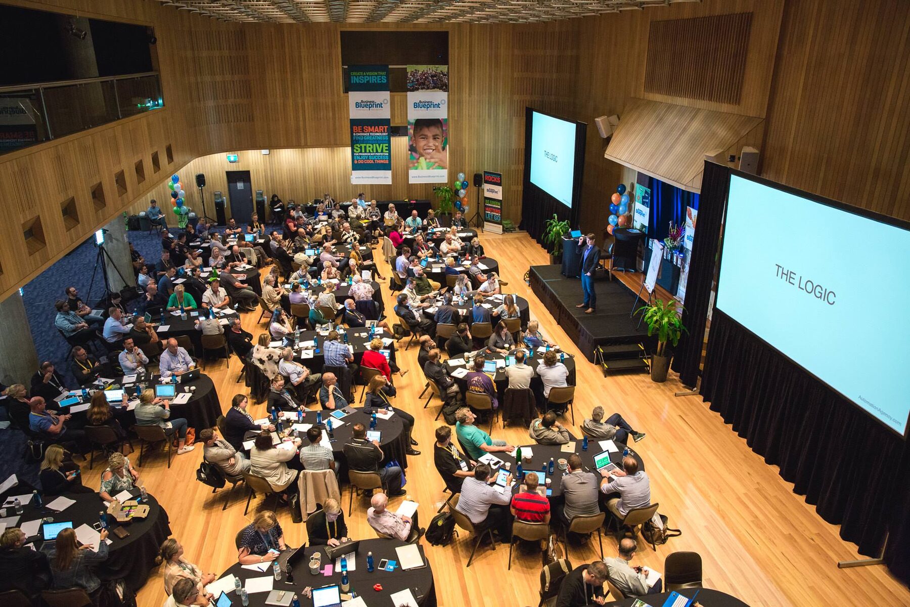 Carl Taylor delivering a keynote to a conference room of hundreds of business owners